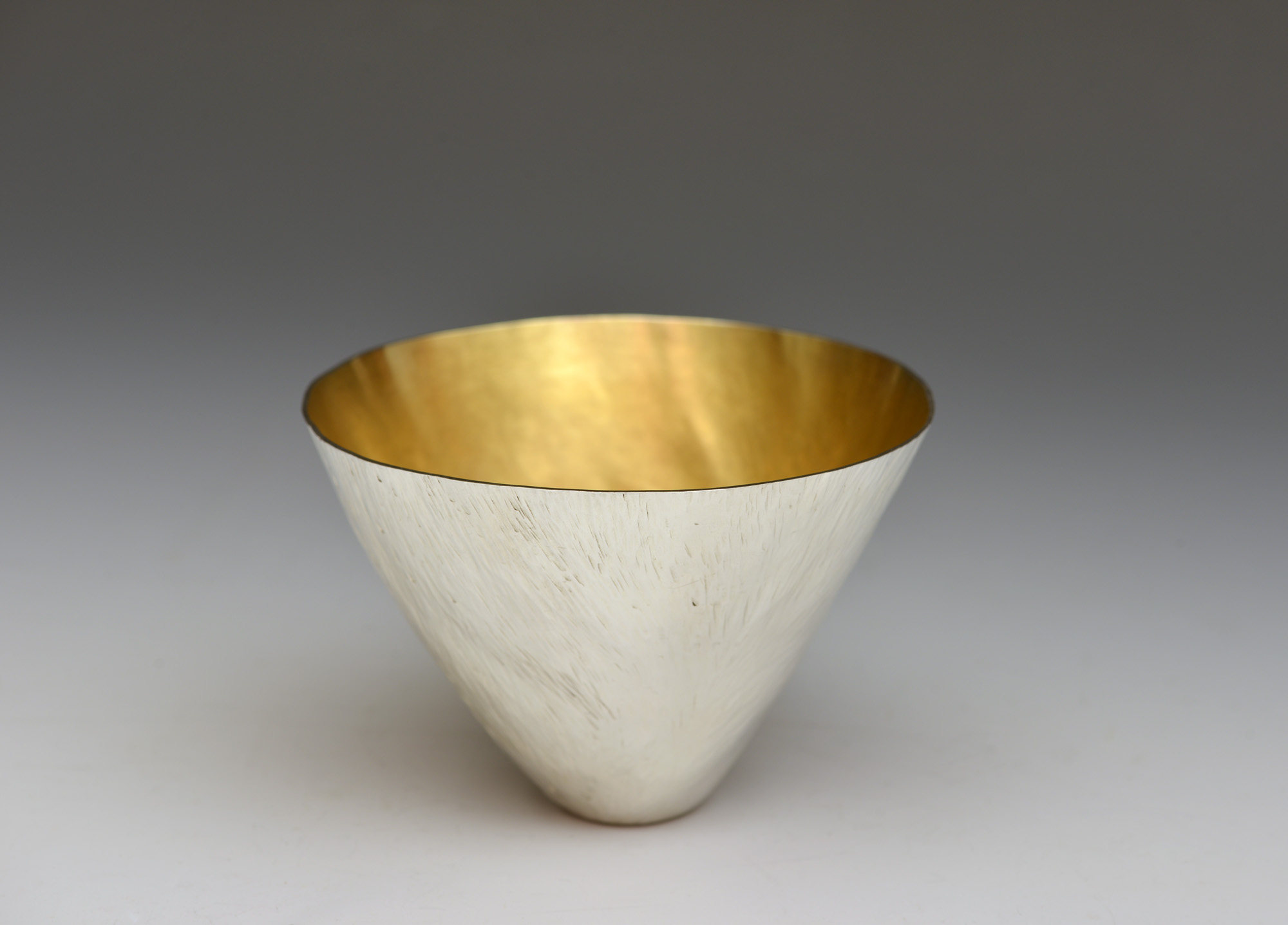 A water beaker by Rebecca-Anne Boldra: made of Britannia Silver, plannished with an internal gold hard plate and commissioned in 2017