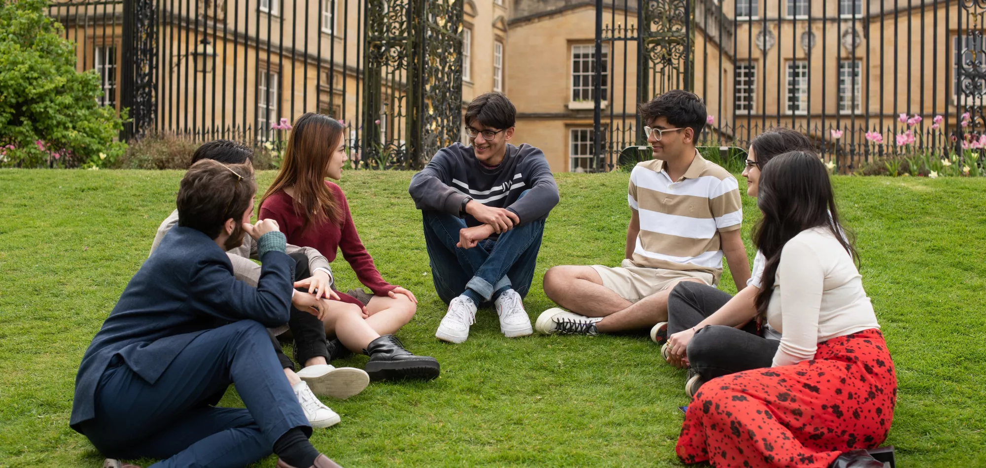 Students sitting on the grass in New College gardens