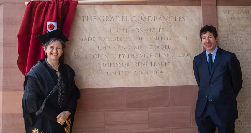 The VC and Chris Gradel stand by the ceremonial stone in New College's Gradel Quadrangles