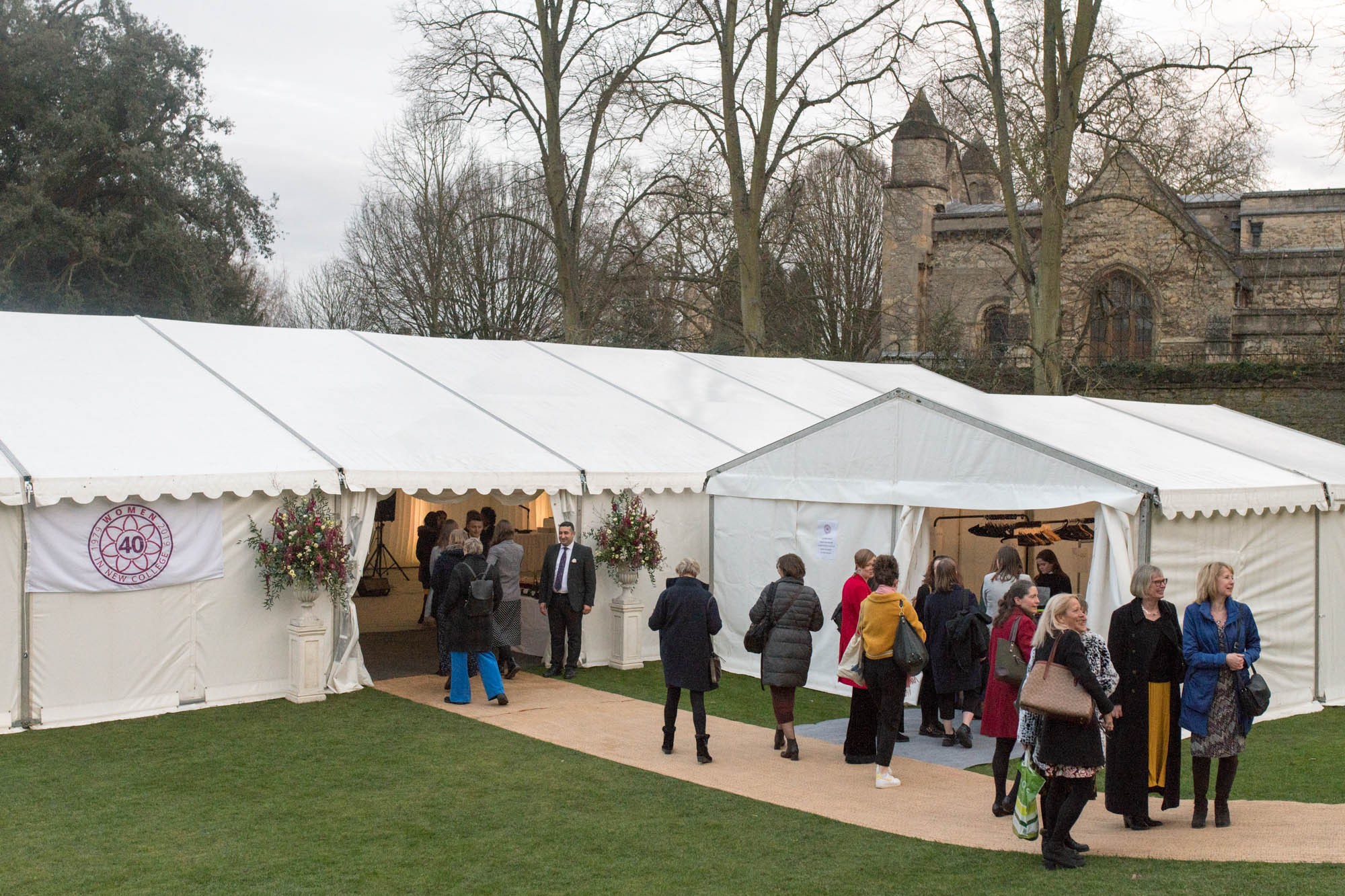 Attendees enter the marquee in the Gardens