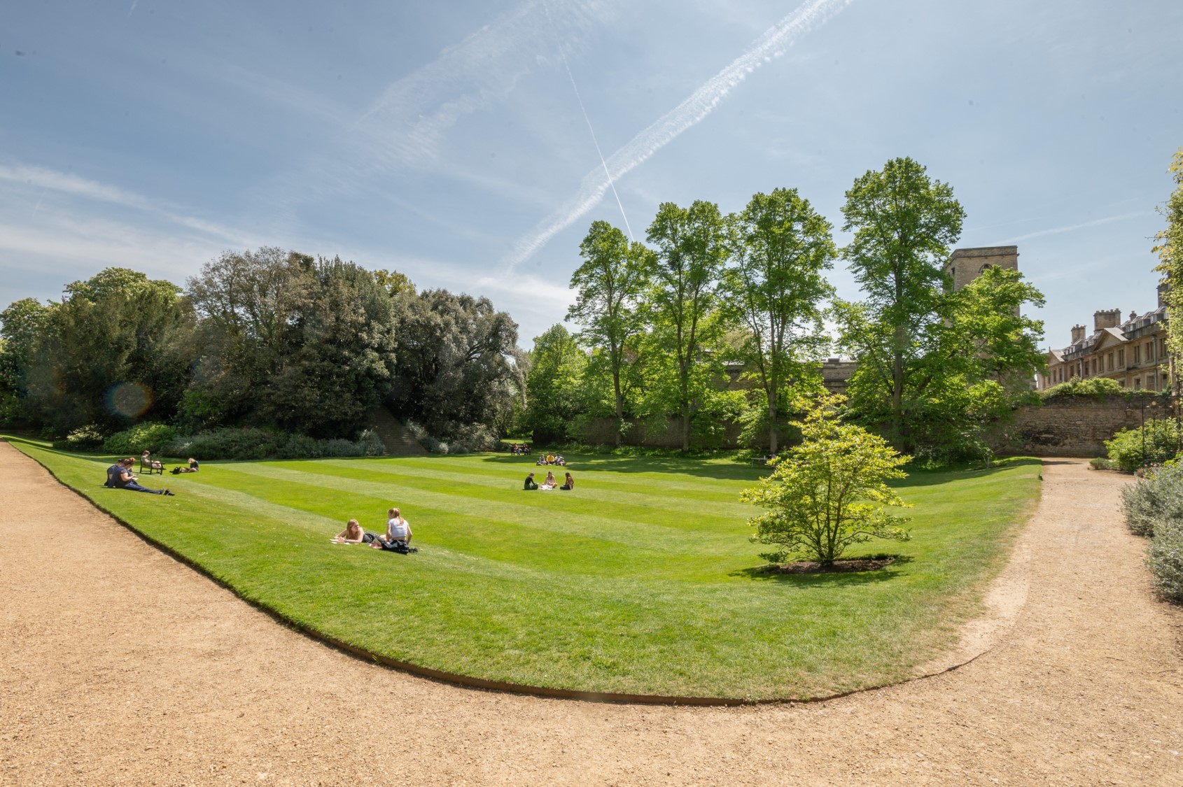 Students lying on the grass in the gardens