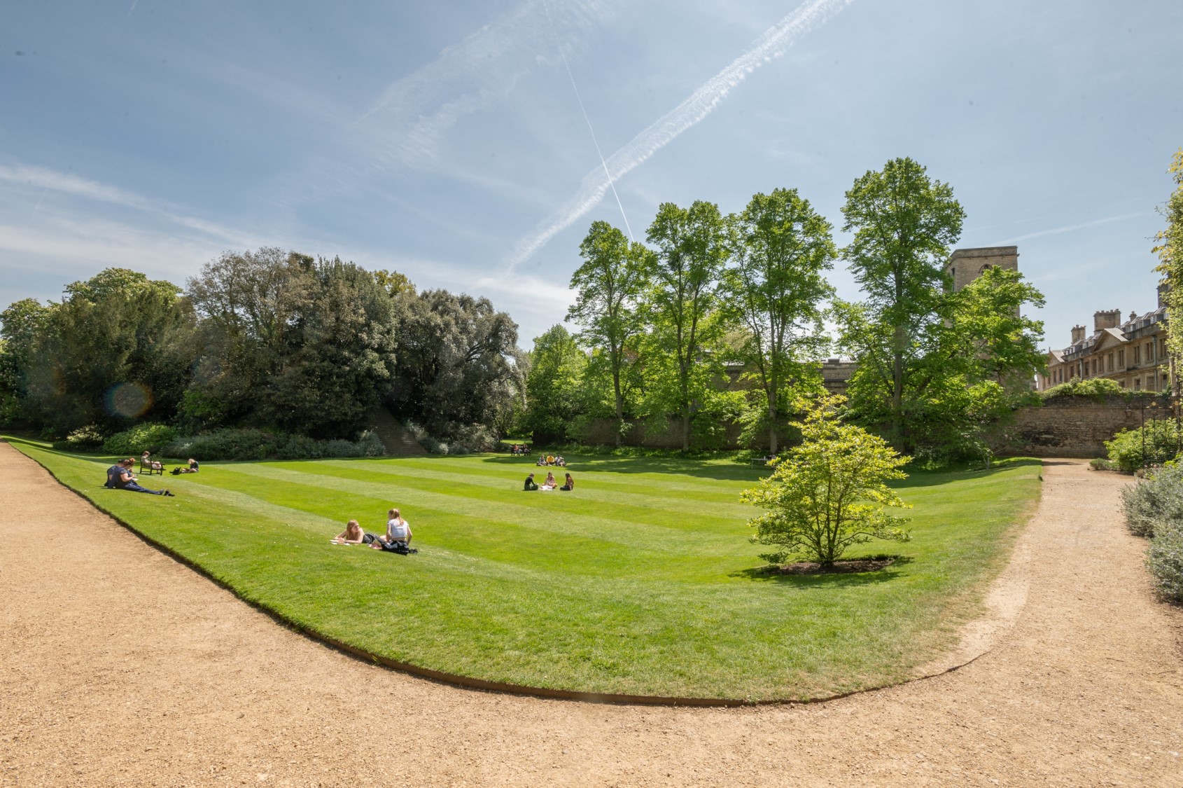 Students enjoying the sunshine in the gardens Students lying on the grass in the gardens