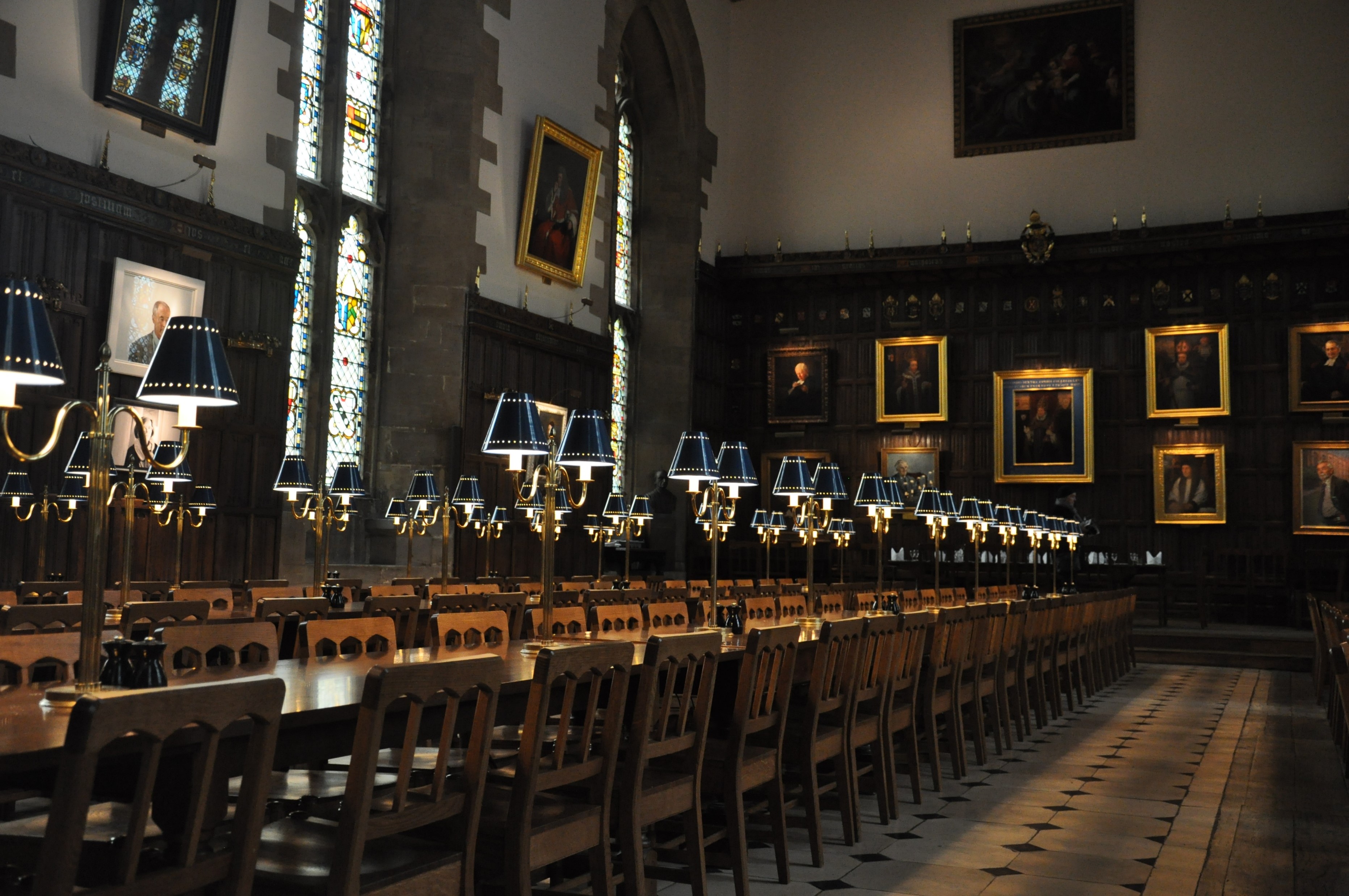 Dining Hall, including lights with blue lampshades, and paintings on the walls