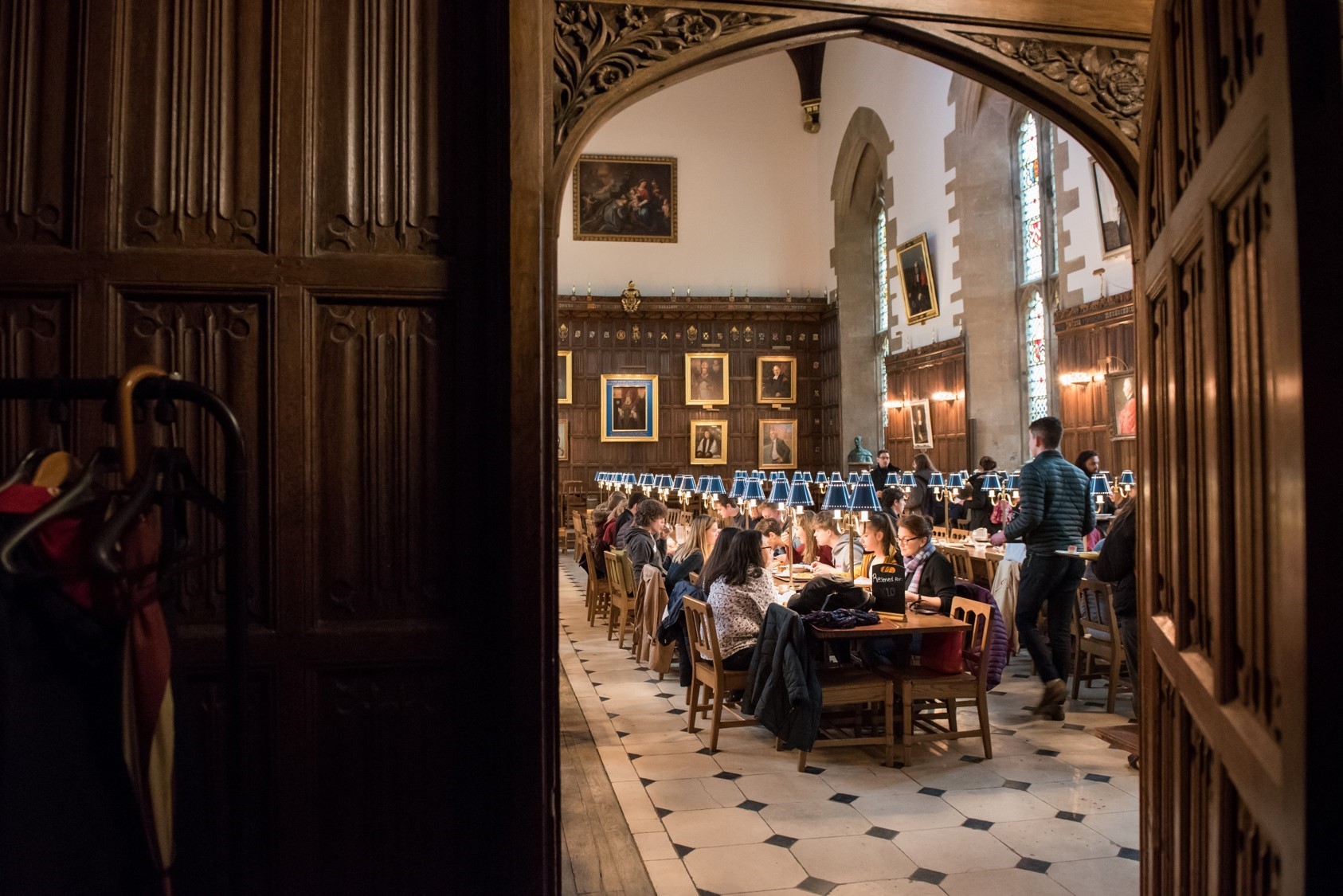 Students eating in Dining Hall, seen through doorframe