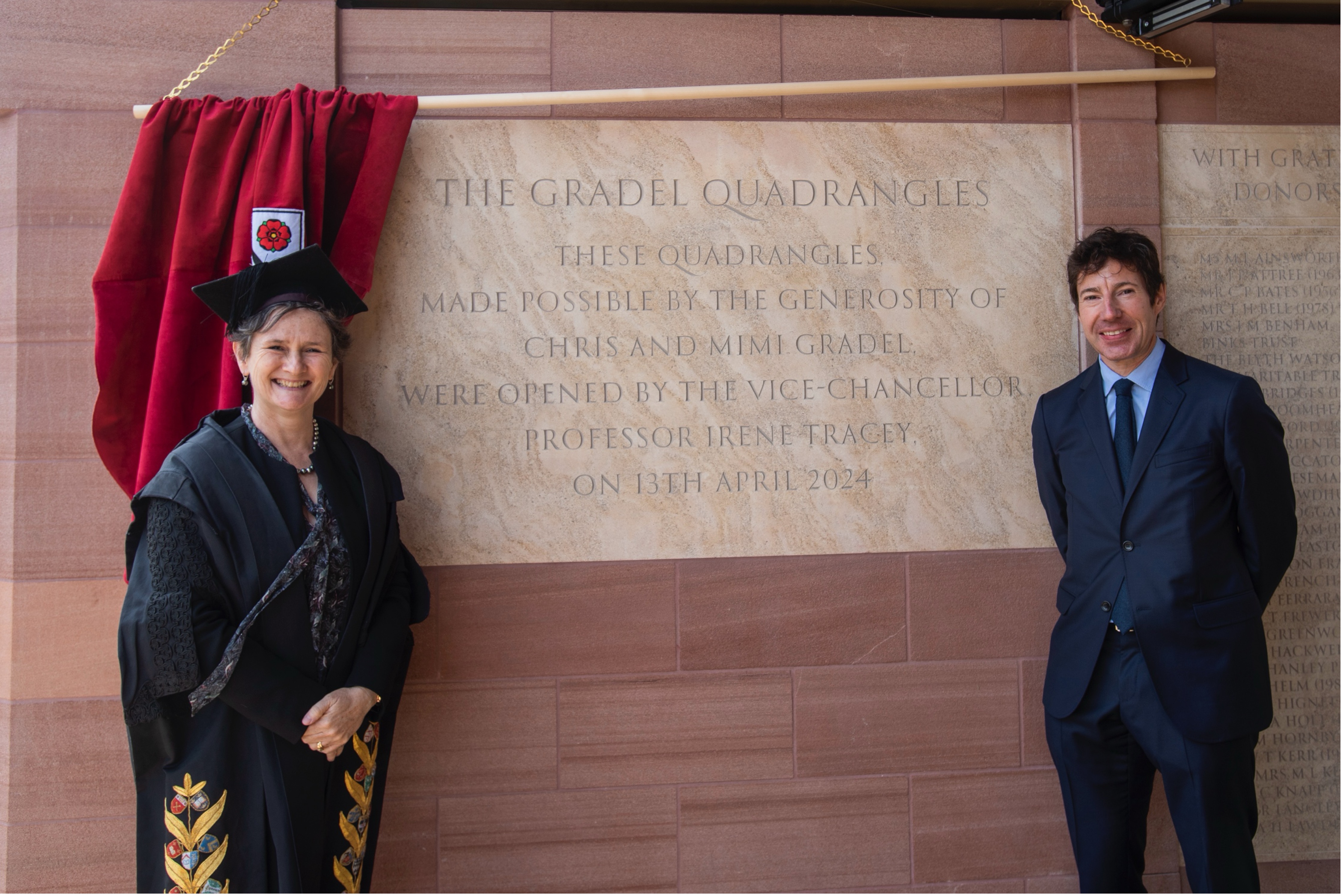 The VC stands with Chris Gradel next to the ceremonial stone marking the opening of the Gradel Quadrangles