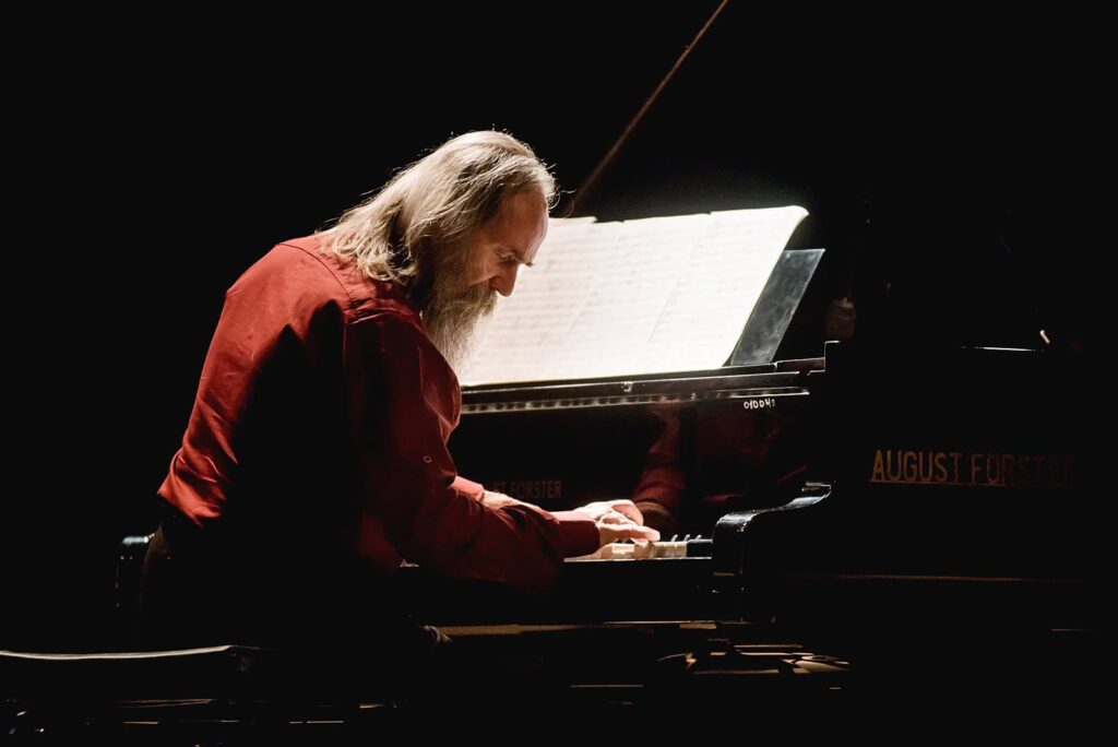 Lubomyr Melnyk playing on a concert grand with closed eyes