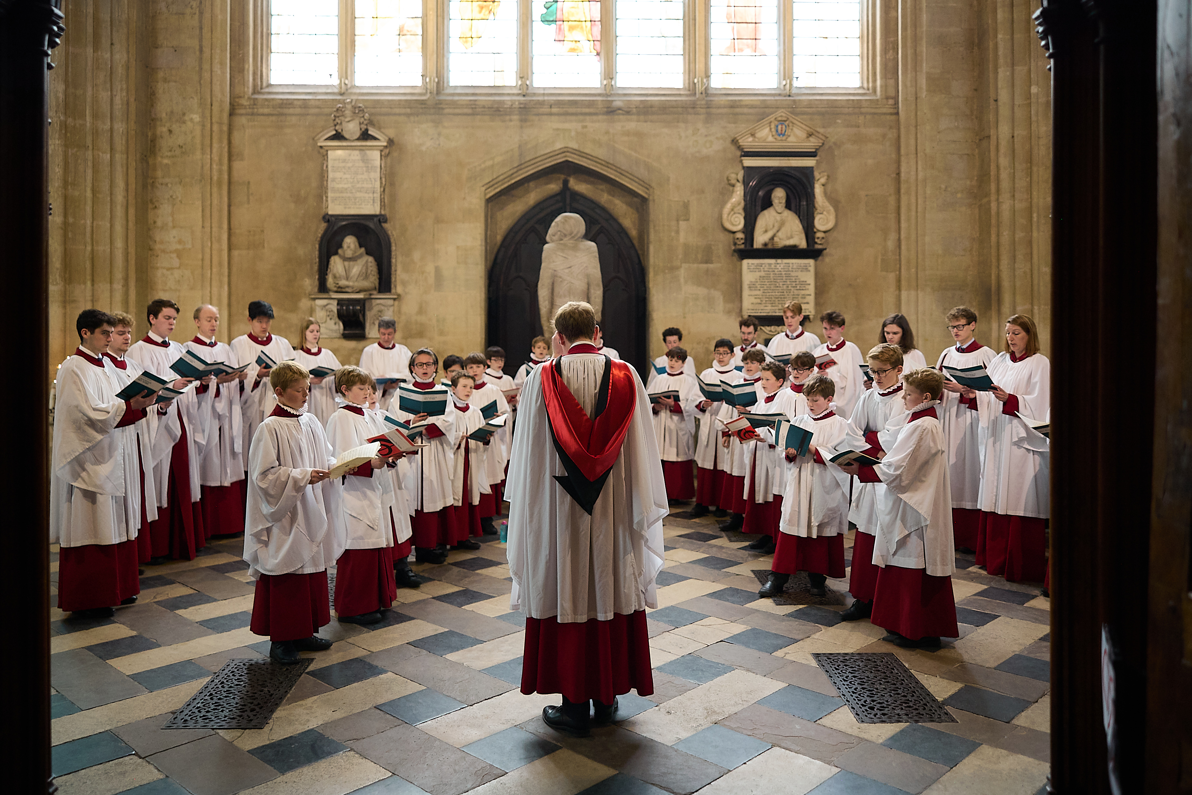 A picture of New College Choir standing in the New College Antechapel, taken by Ian Wallman