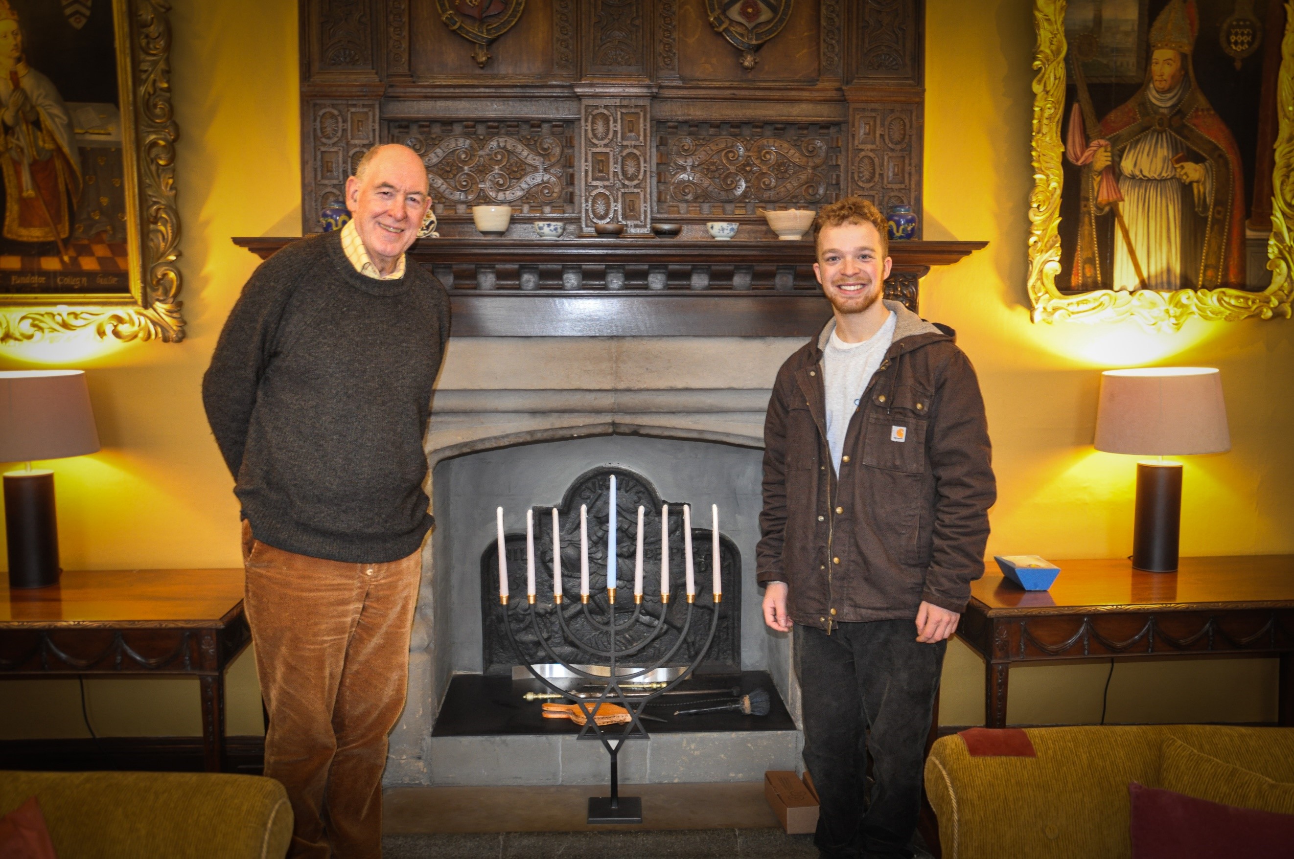 The Warden and Charlie (Co-President of New College JSoc) stand in the Warden's lodgings to inspect the new menorah