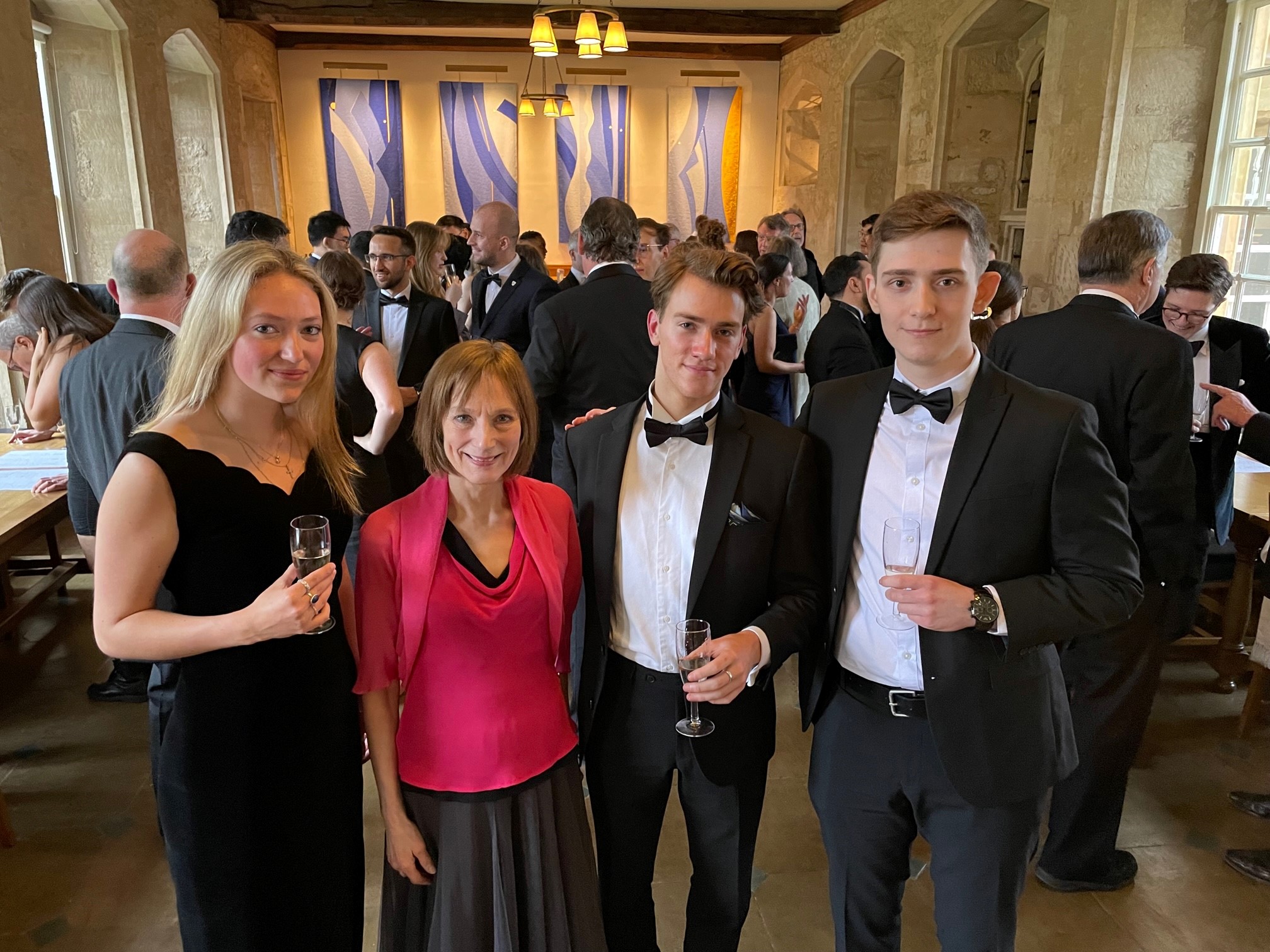 Four people in formal dress smiling at the camera