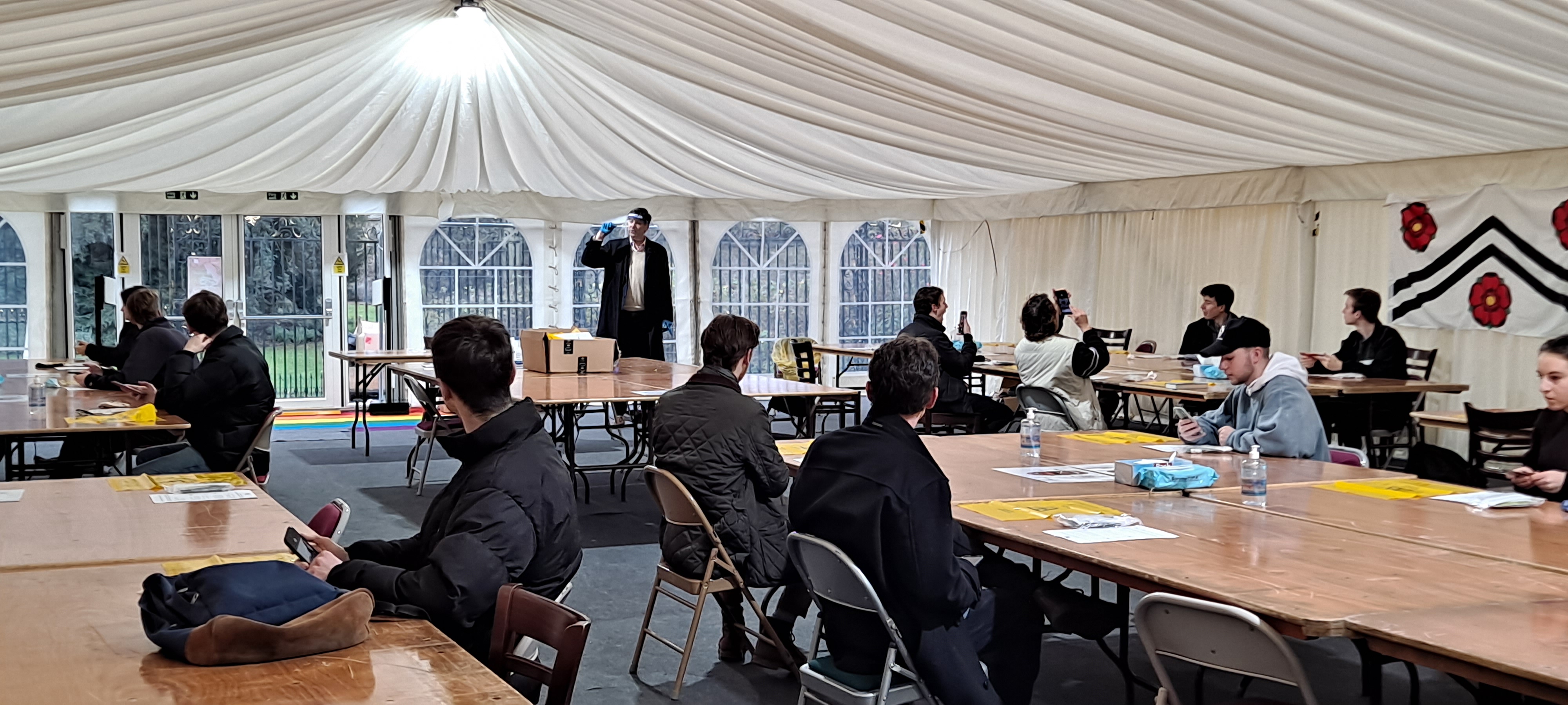 Students being trained in how to take lateral flow tests in the marquee