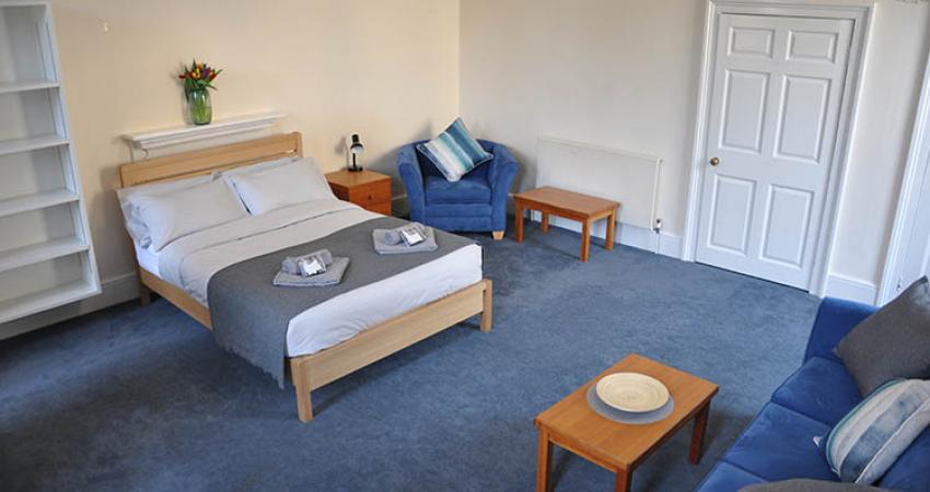 Bedroom with double bed, chair and sofa