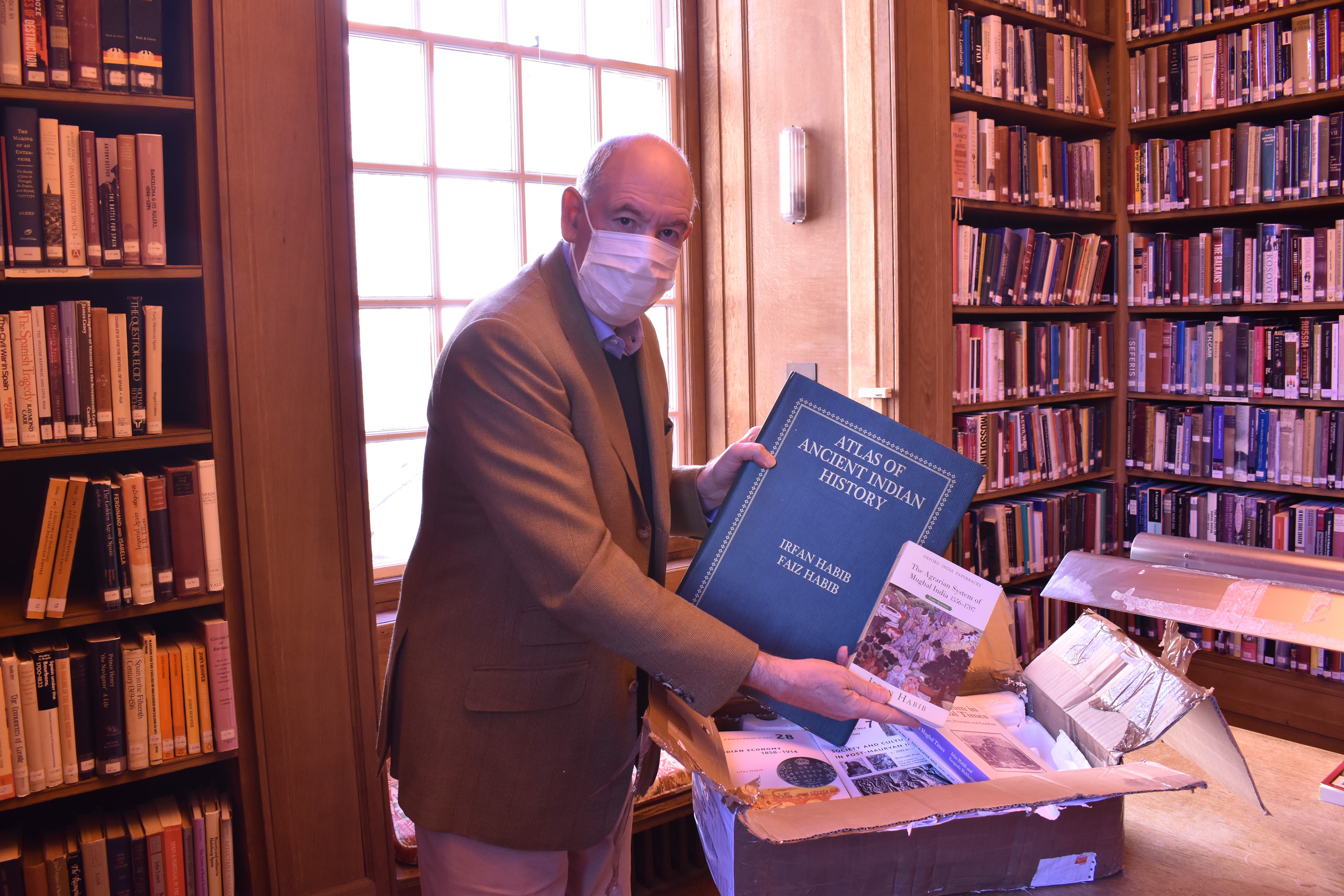 The Warden in the Library with the books gifted by Prof Irfan Habib
