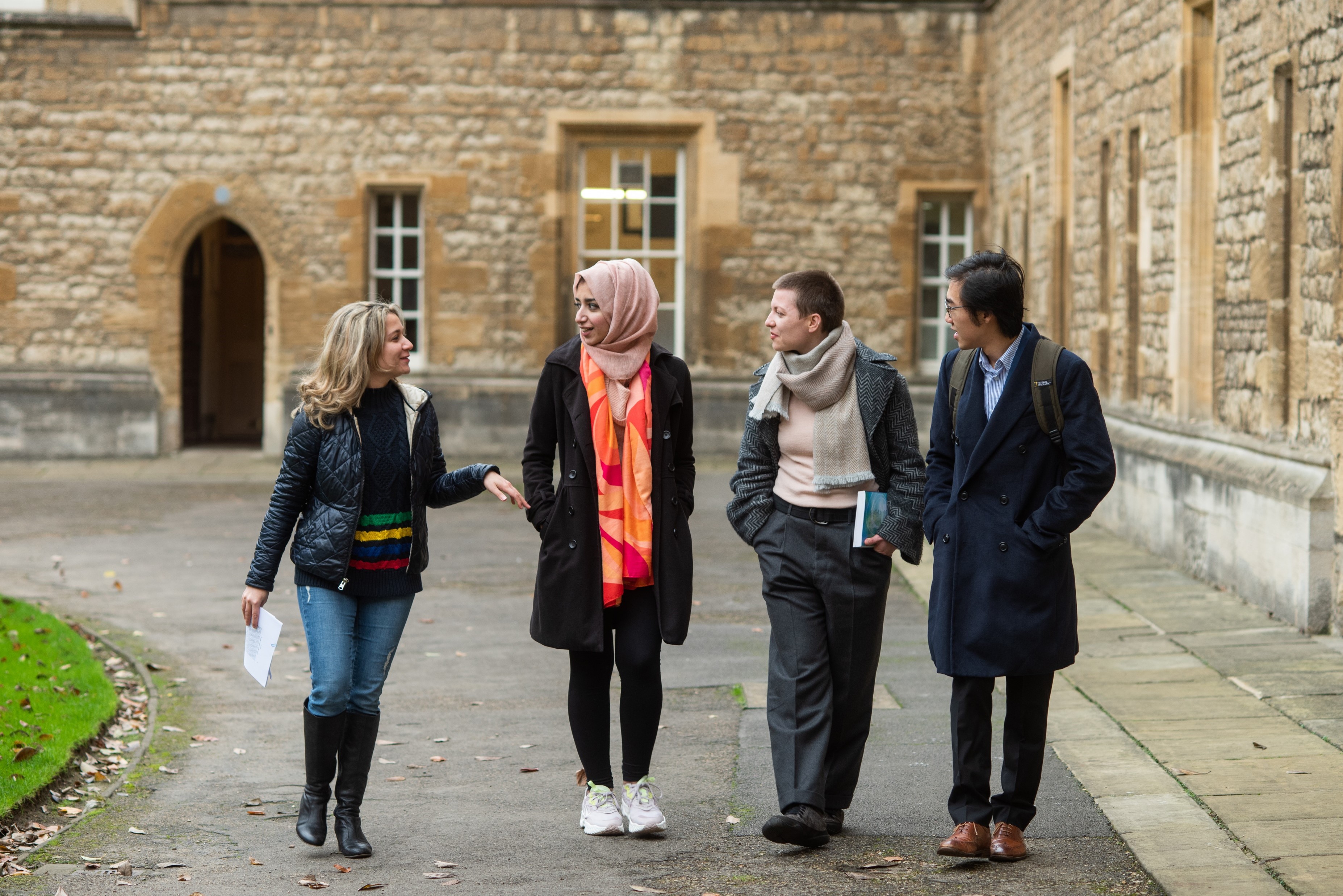 Four students walking in Front Quad