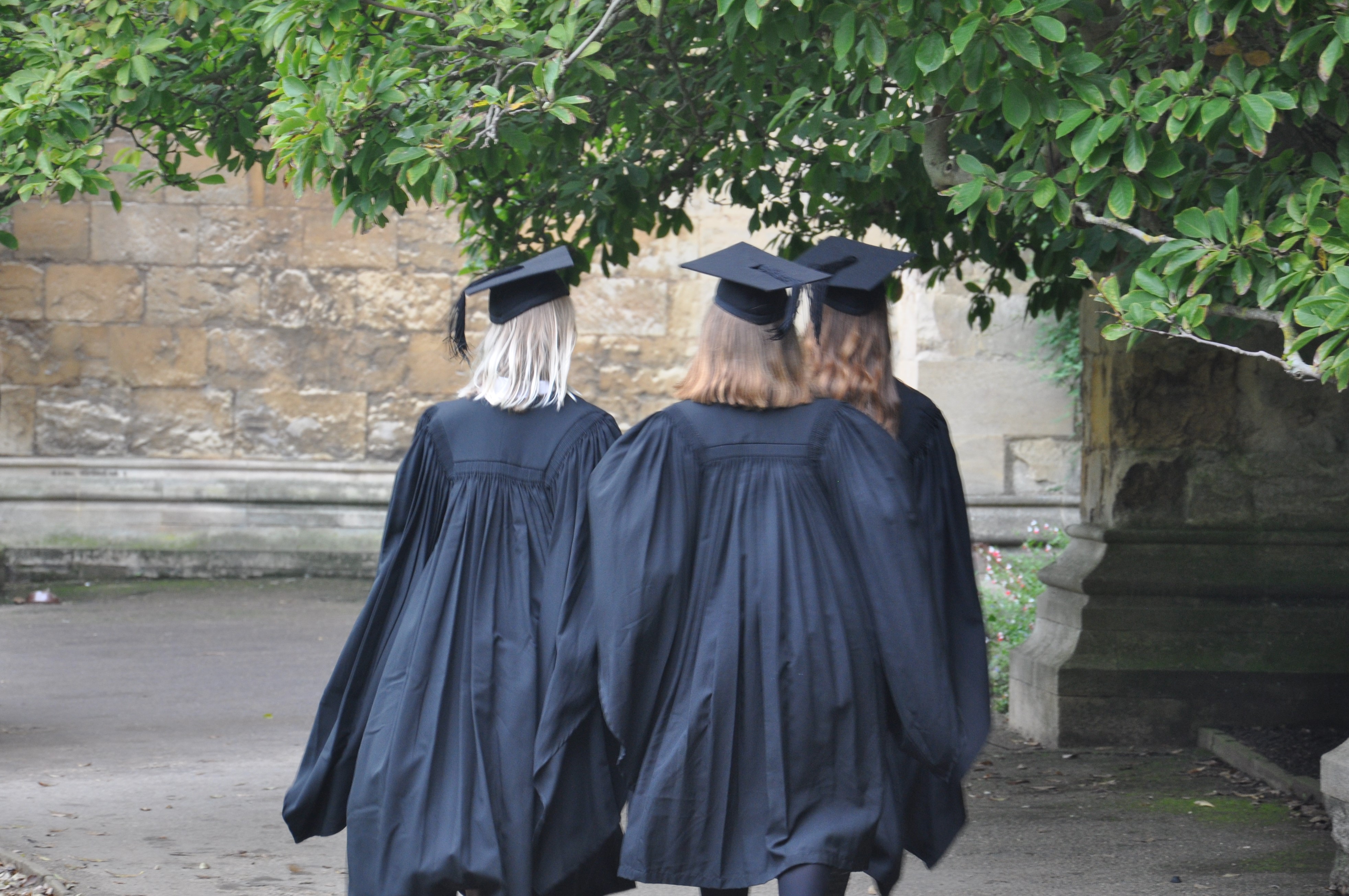 Students in mortarboards and gowns in Front Quad