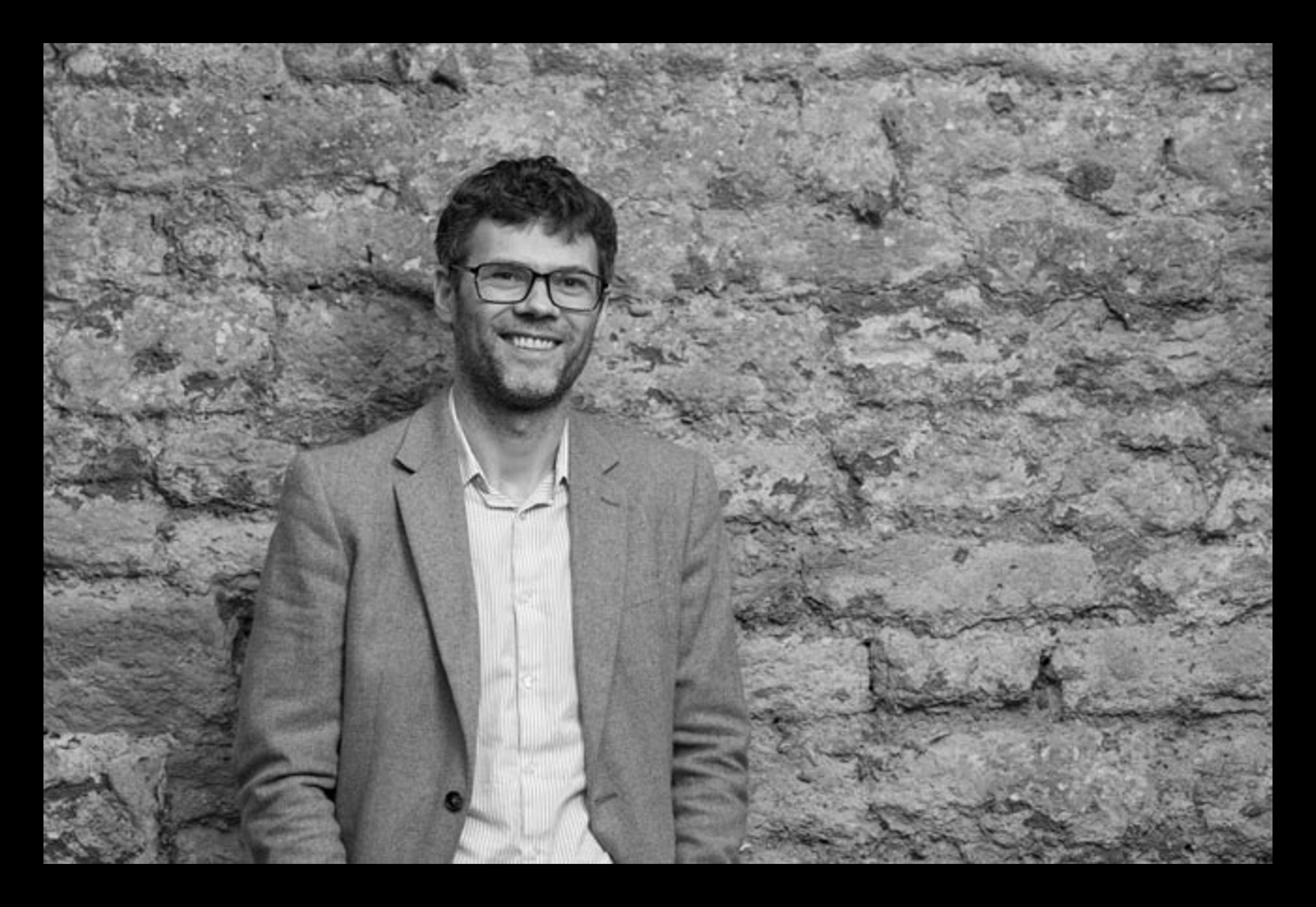 Black and white photo of Mark Stokes with black border