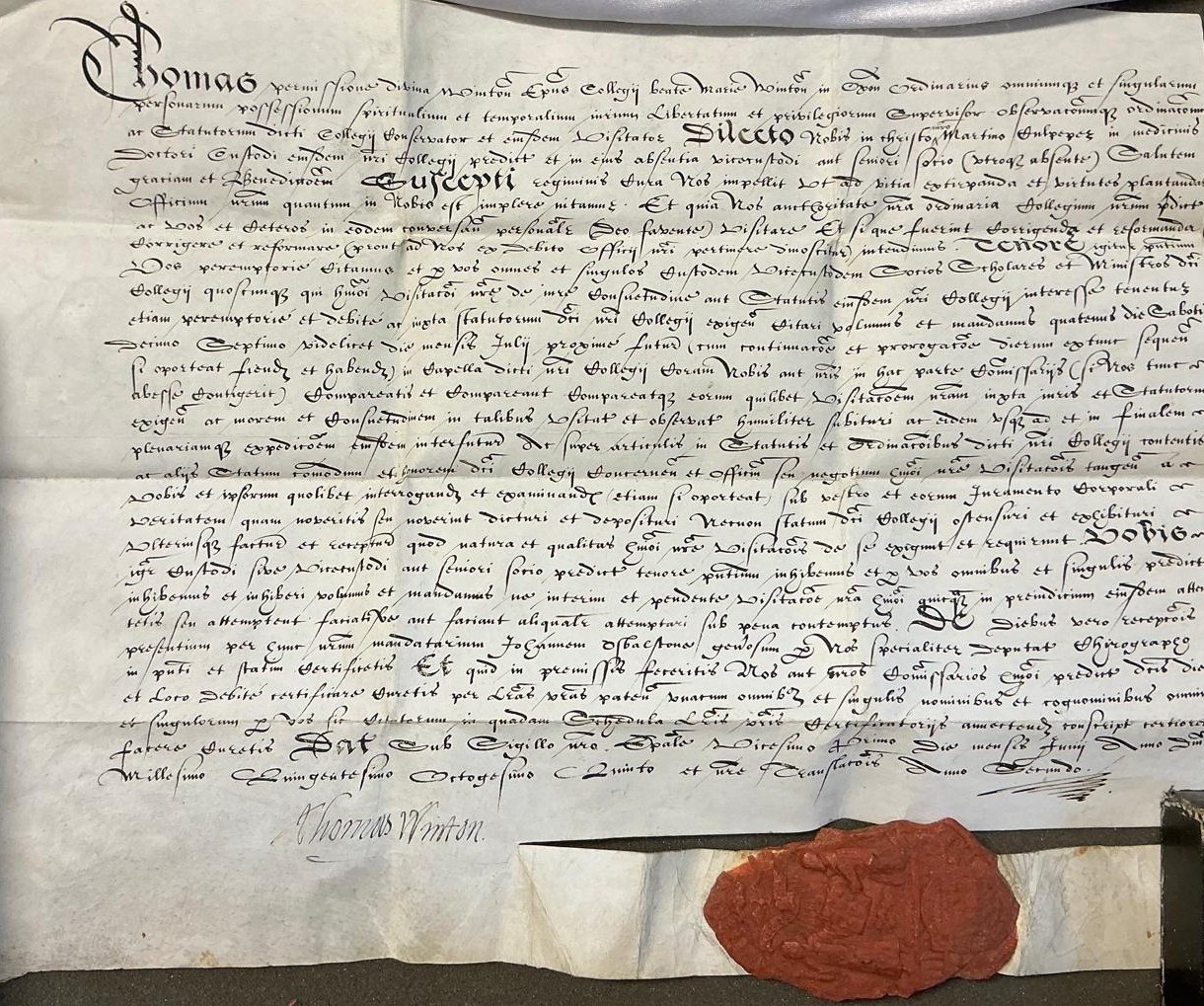 A handwritten document in black ink with a red wax seal at the bottom.
