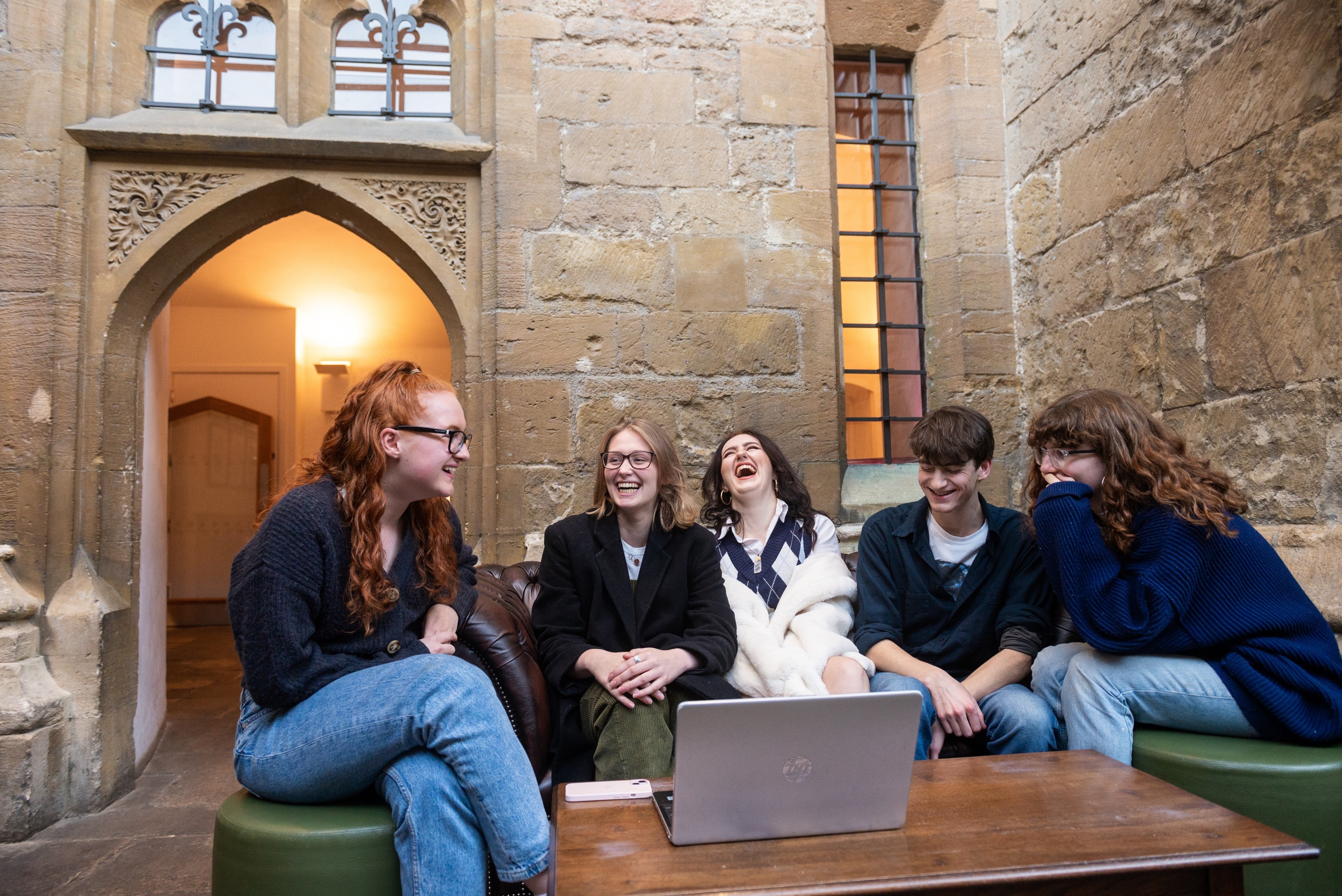 Five students laughing in the bar