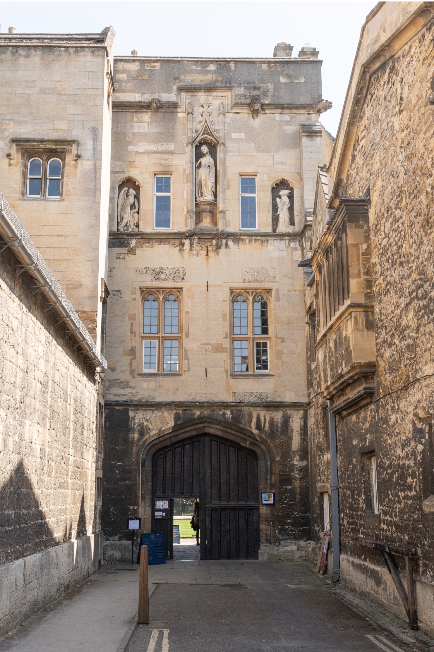 Visitors Entrance exterior with wooden gate and carved statues