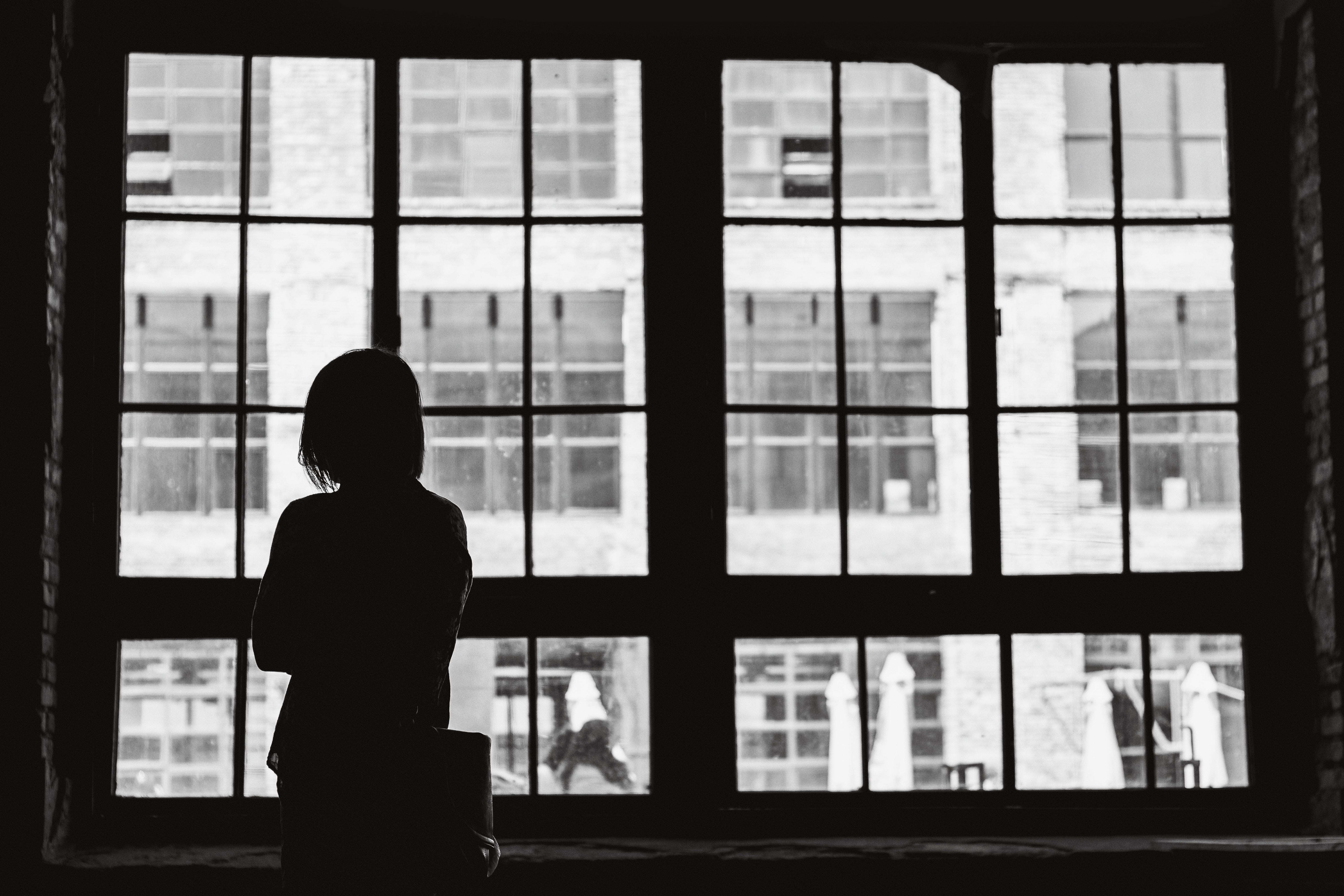 Woman silhouetted against window