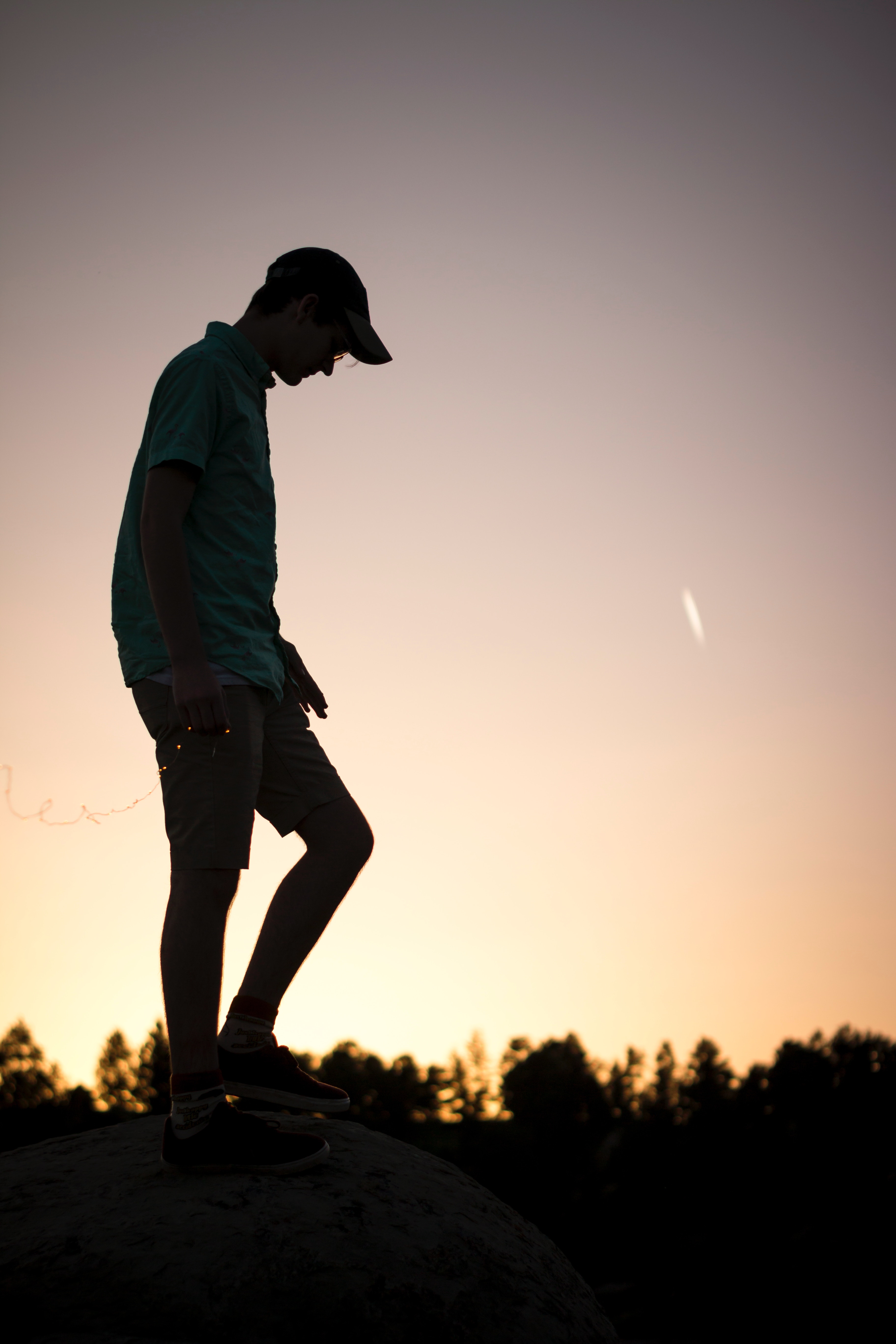 Young man alone on a rock