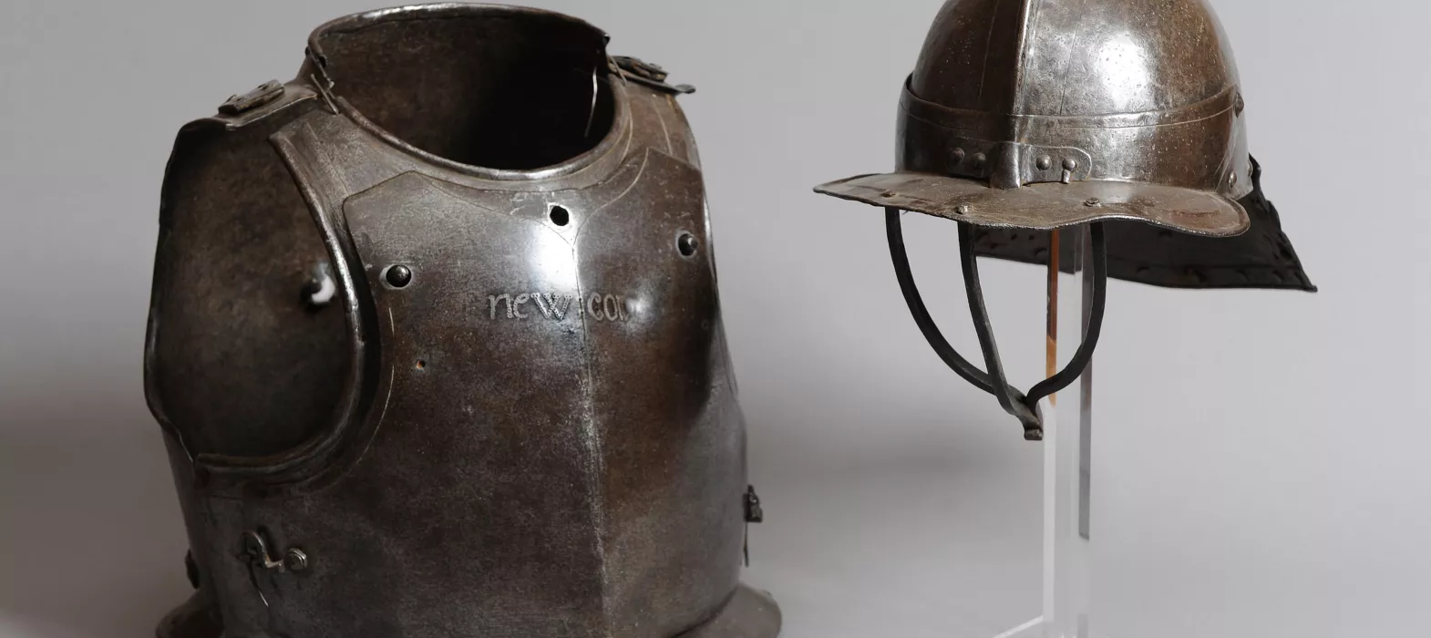 Breast plate and helmet with New College inscribed. 