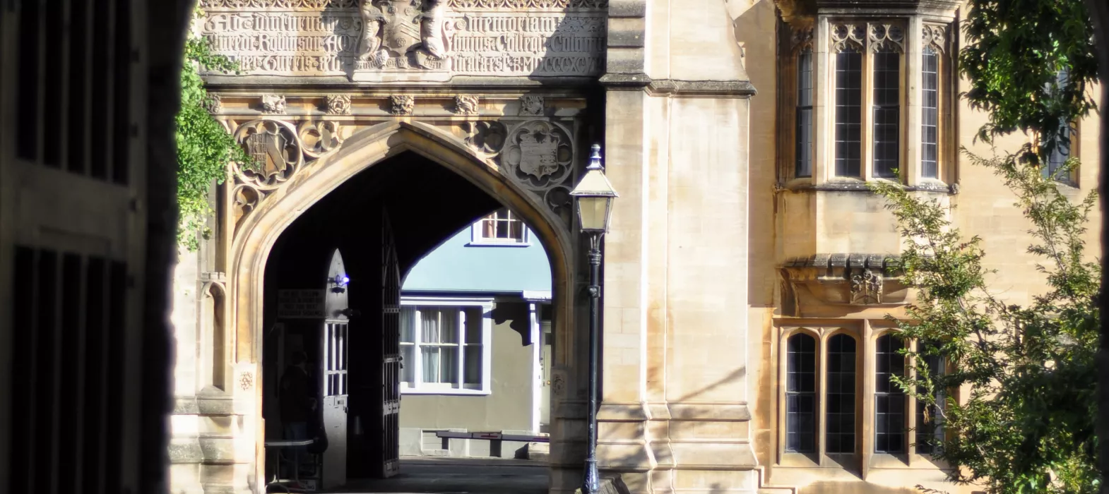 A photo looking through the old city wall archway to the Porters' Lodge