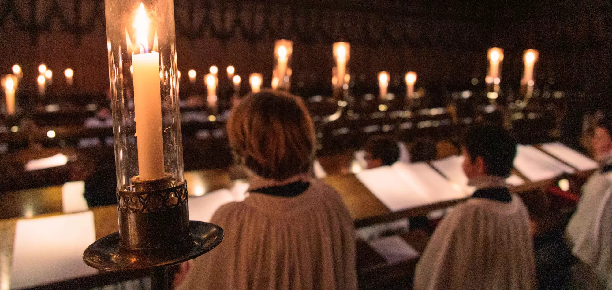 Candles and choristers in chapel
