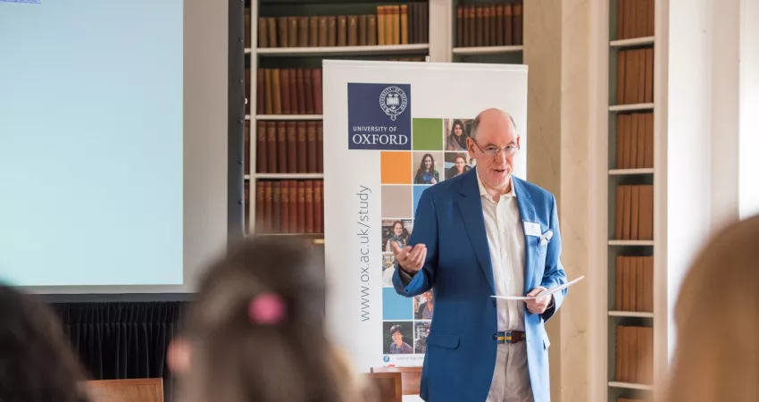 Warden of New College speaking at conference