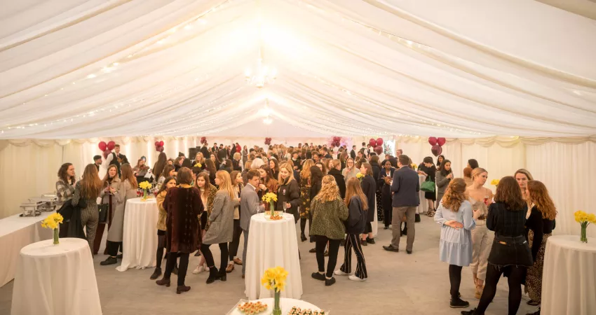 Attendees gather in the marquee