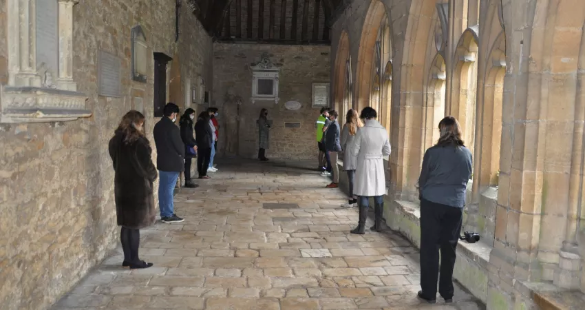 Members of the College lining the walls of the Cloisters