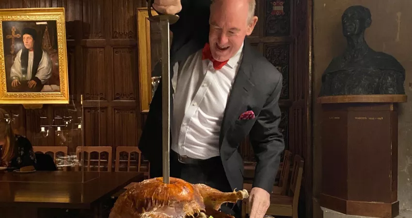 Warden carving turkey with a sword