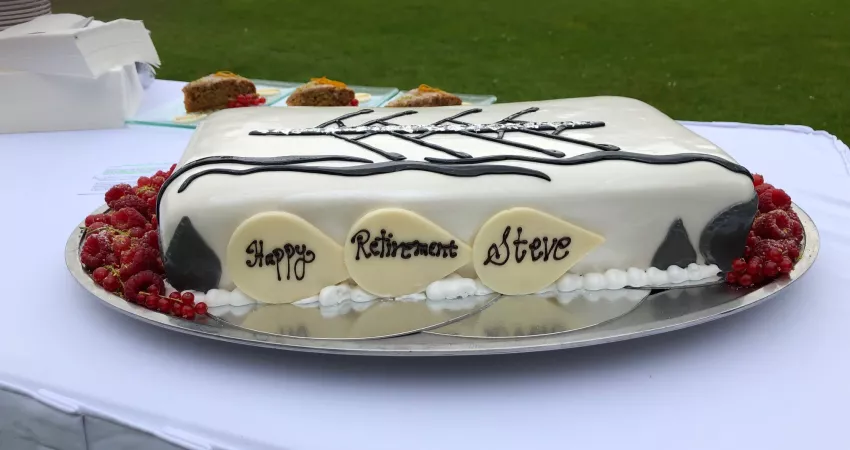 A cake decorated with a boat and 'Happy Retirement Steve'
