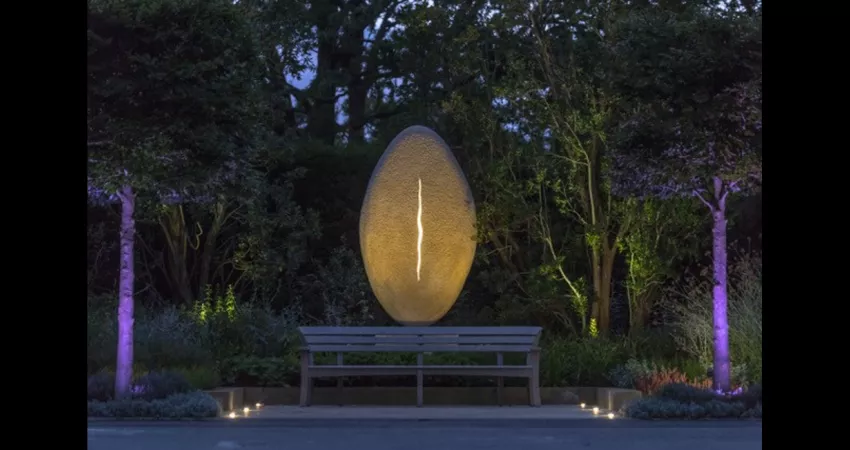 Egg-shaped sculpture with vertical line of light down the middle