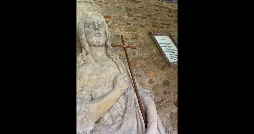 Statue holding a wooden cross