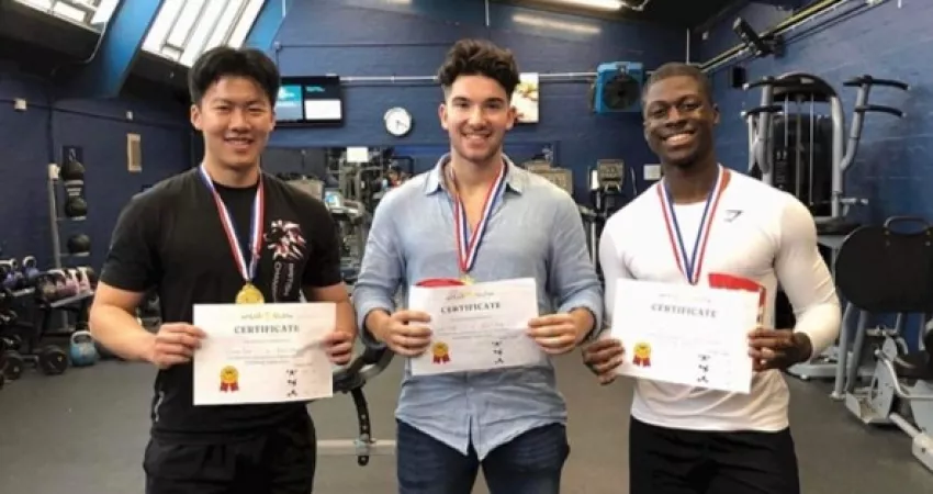 Powerlifting team with certificates