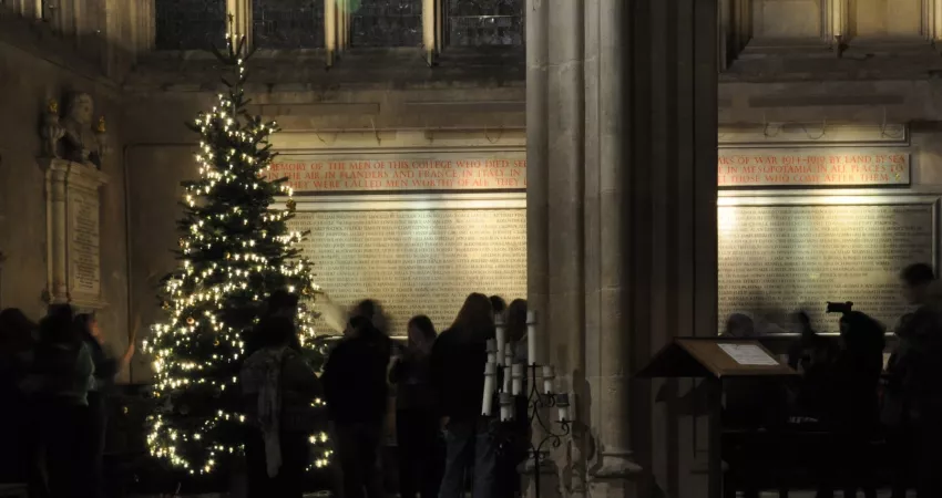 Students surrounding a Christmas tree in the Ante-Chapel