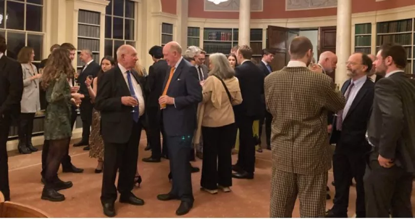 Lots of people talking in small groups at drinks reception