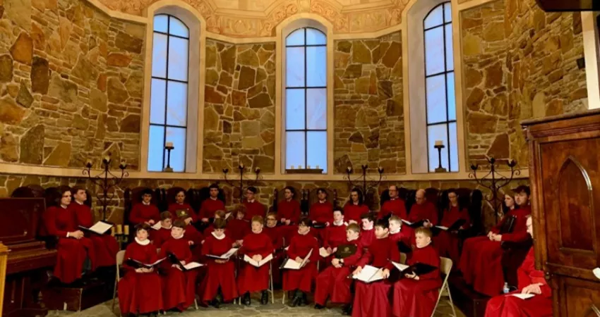 Choir in red robes sat in a Chapel
