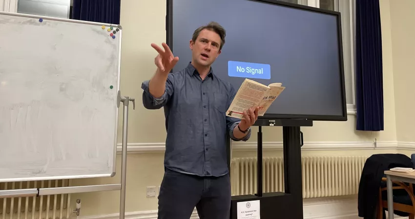 Owen Sheers reads in front of a screen