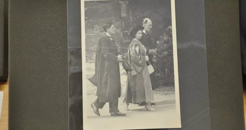A black and white photo of a young Queen Elizabeth II, with the Warden and another man