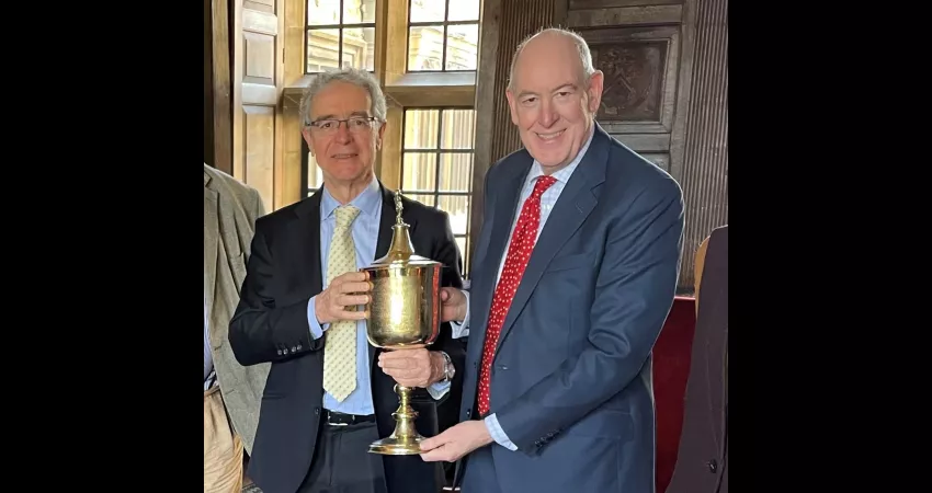 Spanish Ambassador and Warden holding a large, gold, 17th century cup