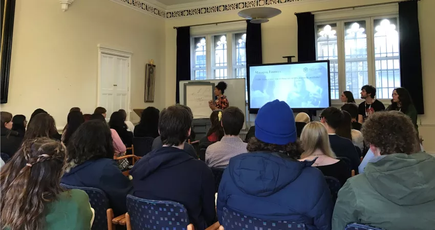 A student presents to an audience