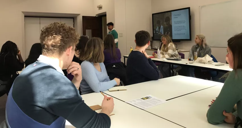 Students sat at white tables