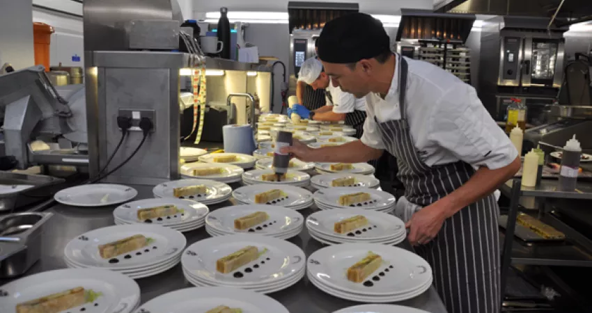 The Executive Head Chef uses a bottle to add purees to the starters