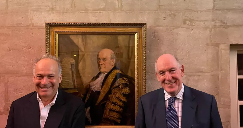 Patrick Lawrence (3rd Baron Oaksey) with Miles Young stand in front of a portrait