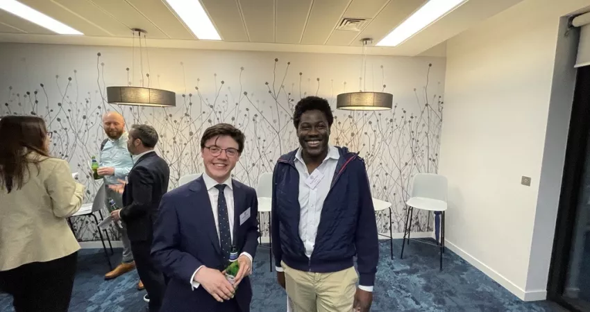 Two guests of the City & Professional Network Drinks smiling