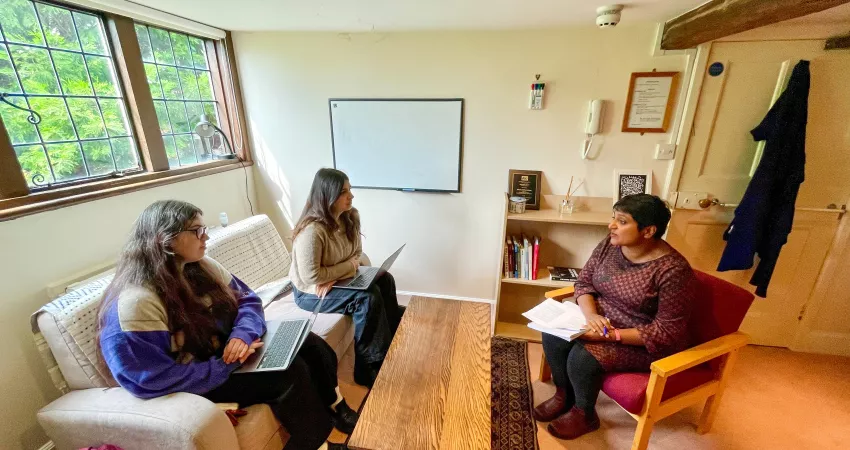 Two Politics students attend a tutorial with an academic