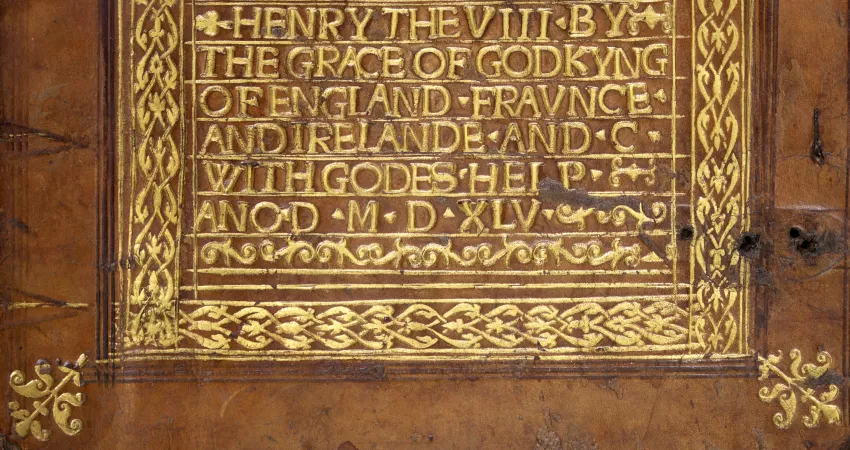 Detail of the gold-tooled binding of MS 136, showing an inscription.