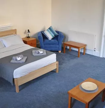 Bedroom with double bed, chair and sofa