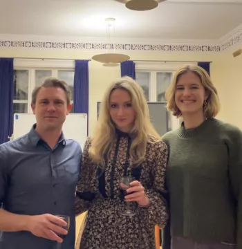 Three people smiling at the camera